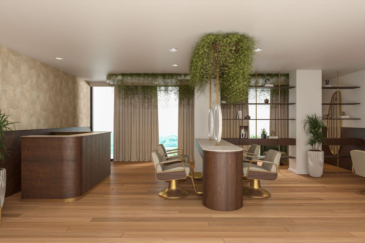 Inside the studio: walnut reception desk, gold styling chairs and hanging greenery