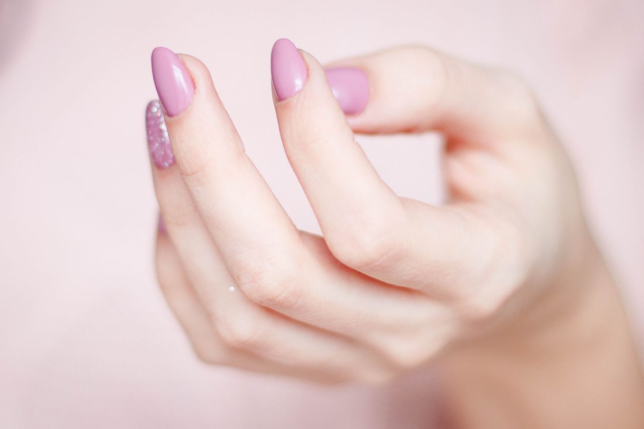 Hand with pastel pink gel polish nails